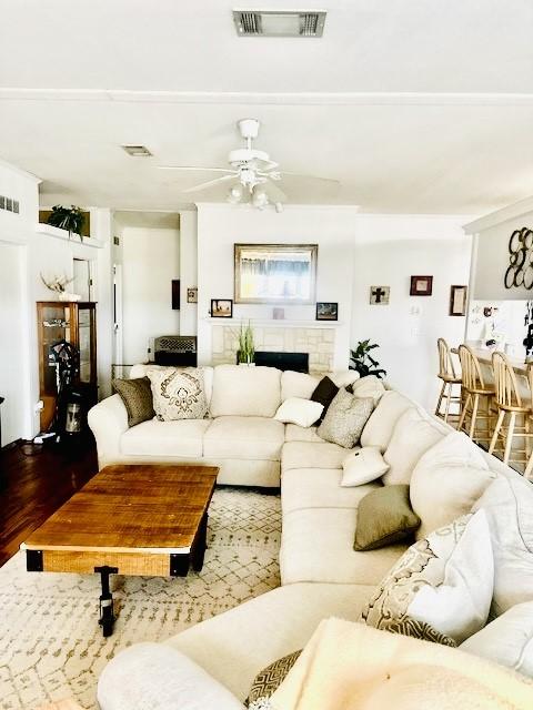 living room with hardwood / wood-style flooring and ceiling fan