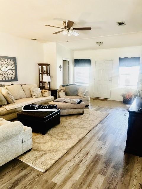 living room featuring hardwood / wood-style flooring and ceiling fan