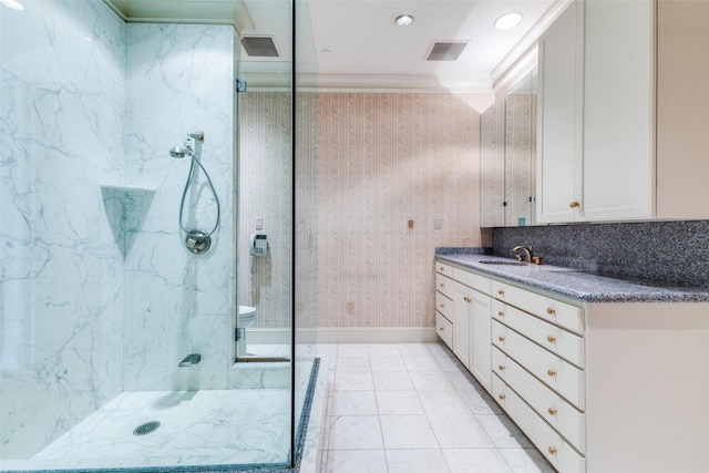 bathroom featuring tile patterned flooring, crown molding, vanity, backsplash, and a tile shower