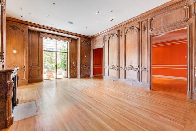 interior space with crown molding and light wood-type flooring