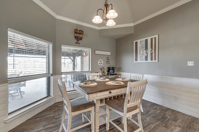 dining room with dark hardwood / wood-style flooring, crown molding, a chandelier, and vaulted ceiling