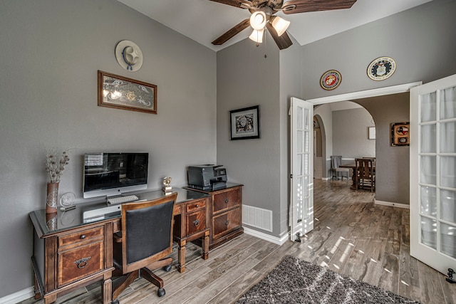 office area with wood-type flooring, high vaulted ceiling, ceiling fan, and french doors