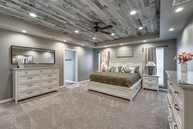 carpeted bedroom featuring wooden ceiling, a tray ceiling, and ceiling fan