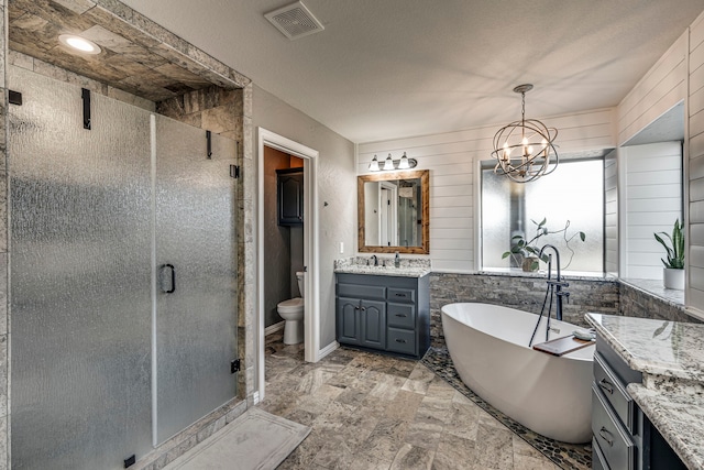 full bathroom featuring toilet, shower with separate bathtub, wooden walls, an inviting chandelier, and vanity