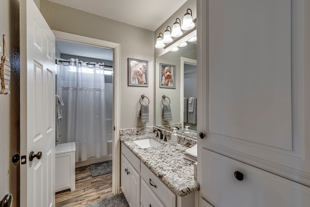 bathroom with vanity, hardwood / wood-style flooring, and shower / tub combo with curtain