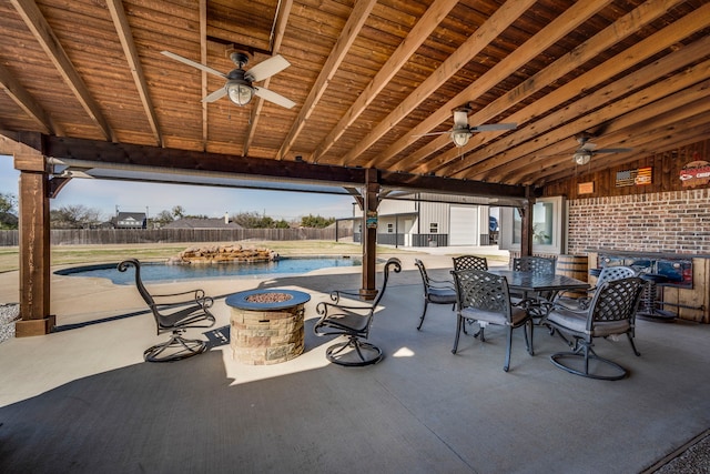 view of patio / terrace with an outdoor fire pit, a fenced in pool, and ceiling fan