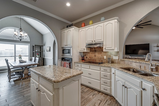 kitchen featuring sink, decorative light fixtures, white cabinetry, decorative backsplash, and stainless steel appliances