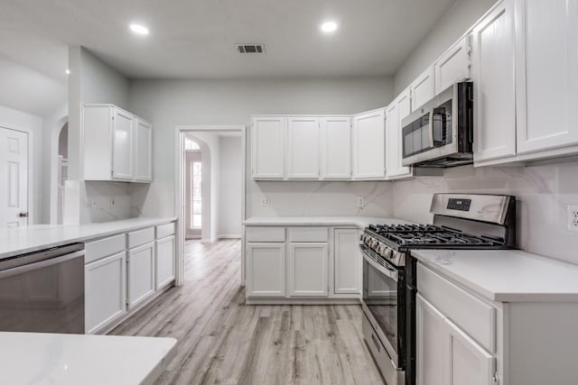 kitchen with white cabinetry and appliances with stainless steel finishes