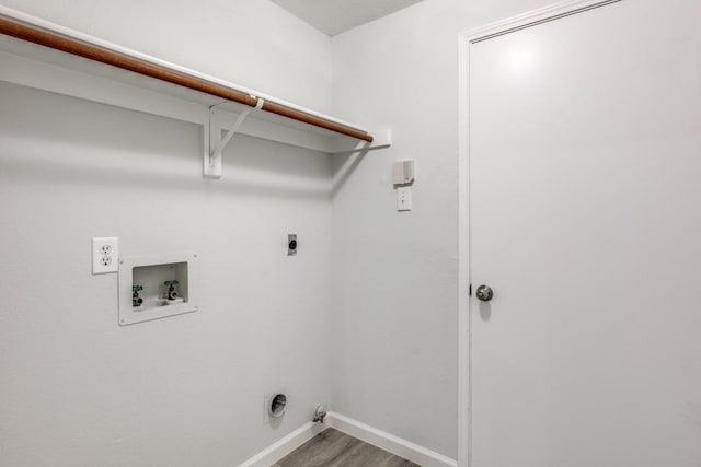 laundry area featuring electric dryer hookup, hookup for a washing machine, wood-type flooring, and gas dryer hookup