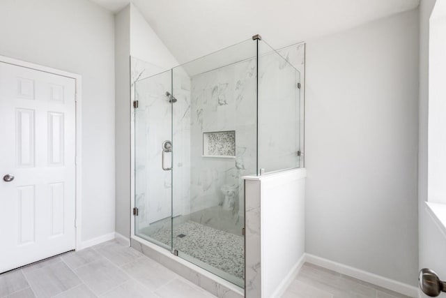 bathroom featuring an enclosed shower and vaulted ceiling