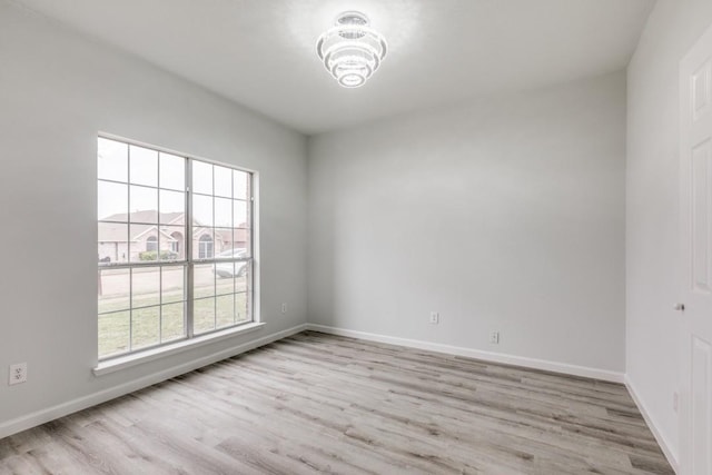 empty room with light hardwood / wood-style flooring