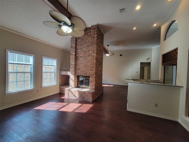 spare room with ceiling fan, ornamental molding, dark hardwood / wood-style floors, and a tray ceiling