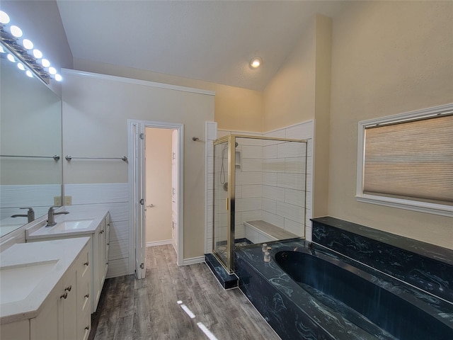 bathroom with wood-type flooring, lofted ceiling, shower with separate bathtub, and vanity