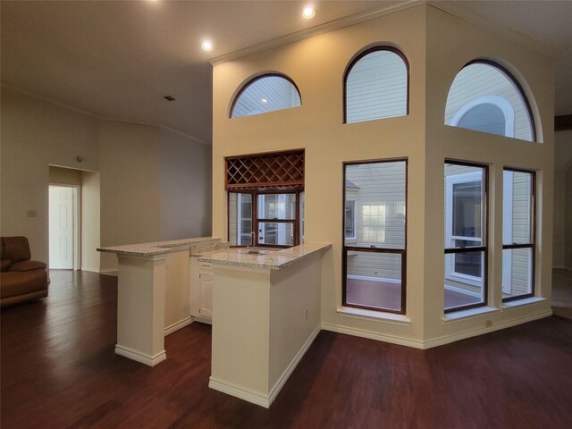 unfurnished living room with ceiling fan, a brick fireplace, dark hardwood / wood-style flooring, and lofted ceiling with beams