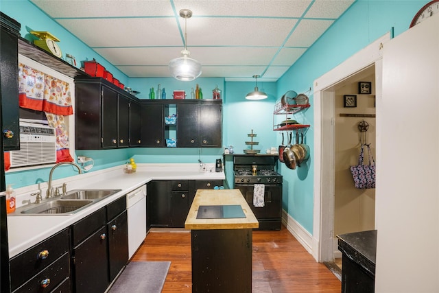 kitchen with black range with gas cooktop, white dishwasher, a drop ceiling, decorative light fixtures, and a kitchen island