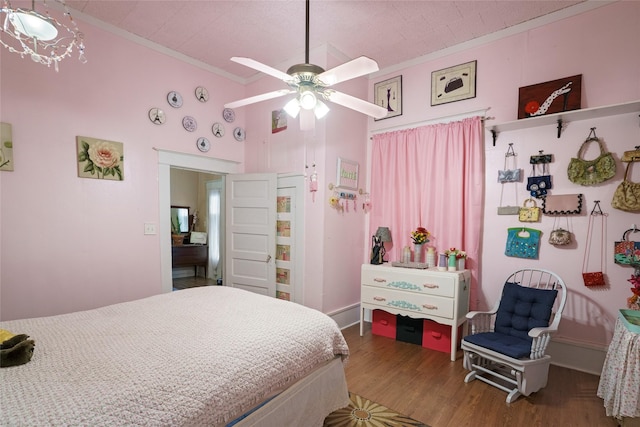 bedroom with wood-type flooring, ceiling fan, and crown molding