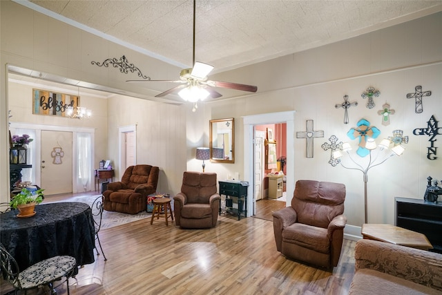 living room with hardwood / wood-style flooring, ceiling fan, and crown molding