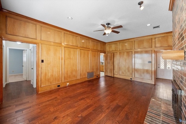 unfurnished living room featuring ceiling fan and dark wood-type flooring