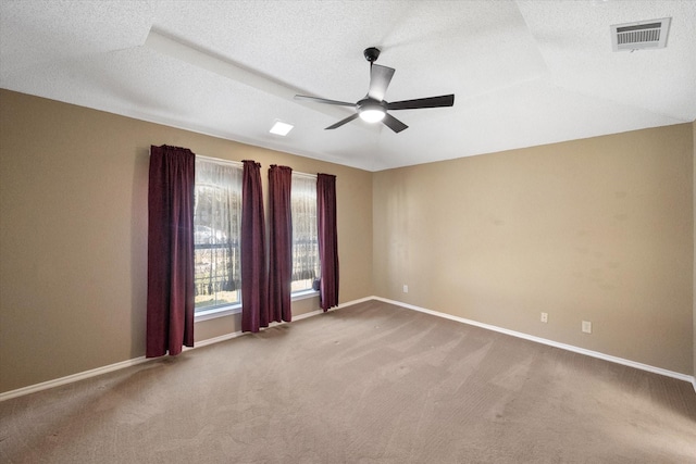 spare room featuring ceiling fan, a textured ceiling, and carpet flooring