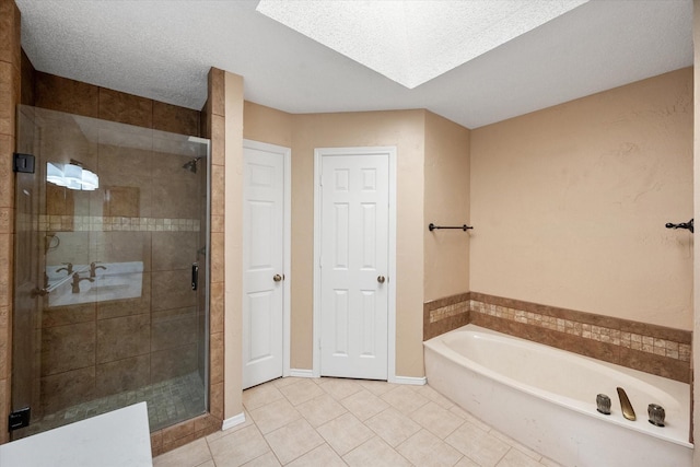 bathroom with a textured ceiling, tile patterned floors, and independent shower and bath