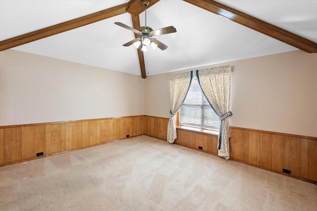 unfurnished room with light colored carpet, vaulted ceiling, and ceiling fan