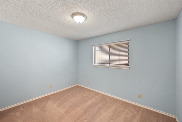 unfurnished room with a textured ceiling and carpet flooring