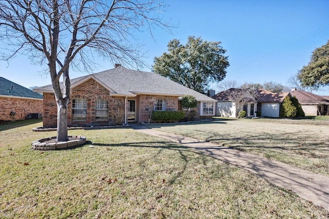 single story home featuring a front lawn