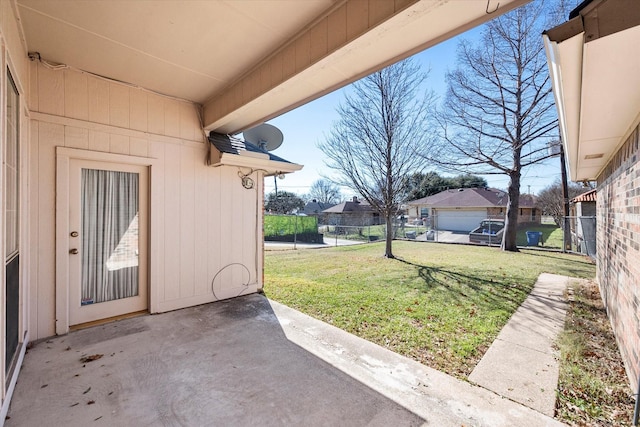 view of yard featuring a garage and a patio