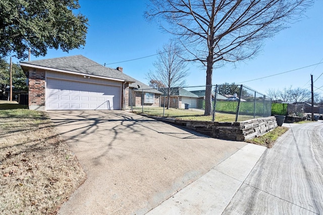 view of front facade with a garage, a front yard, and an outdoor structure