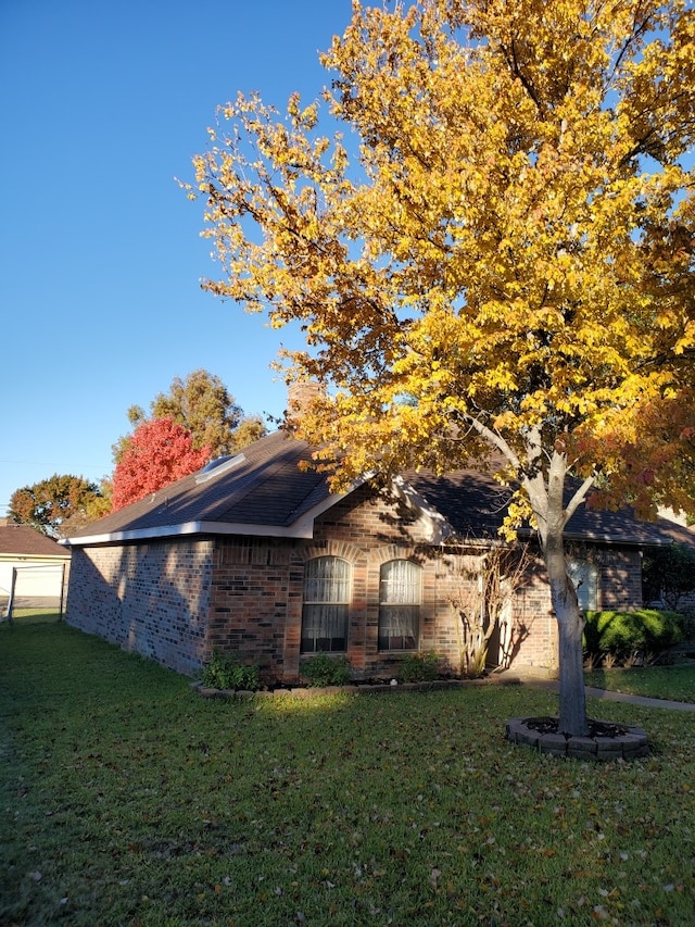 view of side of home featuring a yard