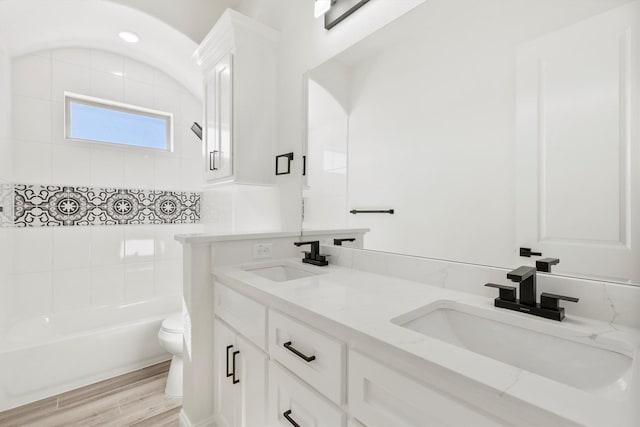 full bathroom featuring tub / shower combination, hardwood / wood-style floors, toilet, and vanity