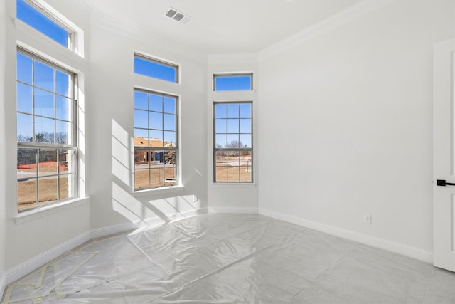 empty room featuring crown molding