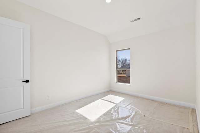 empty room with vaulted ceiling