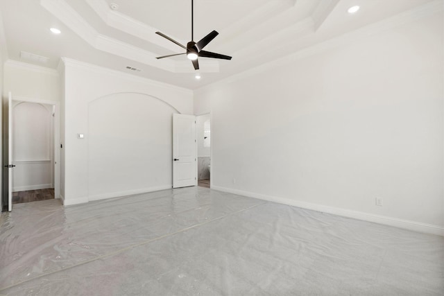 spare room with ceiling fan, a raised ceiling, and crown molding