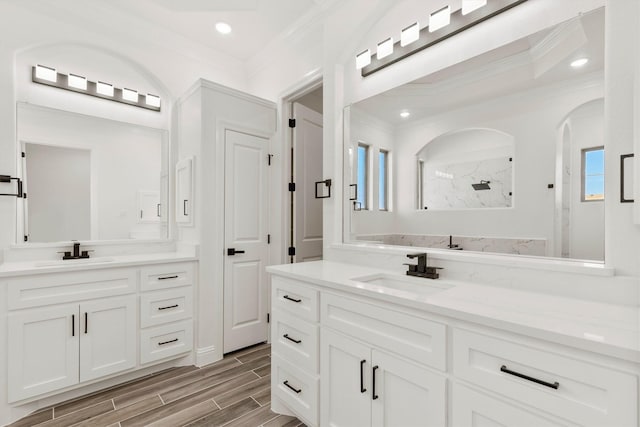 bathroom with walk in shower, ornamental molding, and vanity