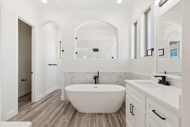 bathroom featuring vanity, hardwood / wood-style flooring, ornamental molding, and separate shower and tub