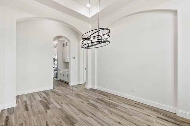 unfurnished dining area with crown molding and light hardwood / wood-style flooring