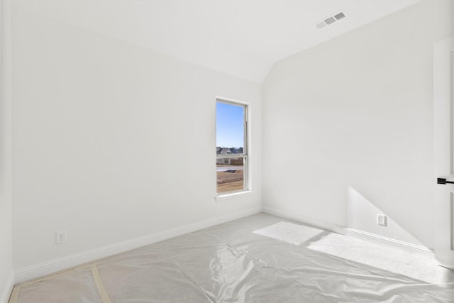 unfurnished room featuring lofted ceiling