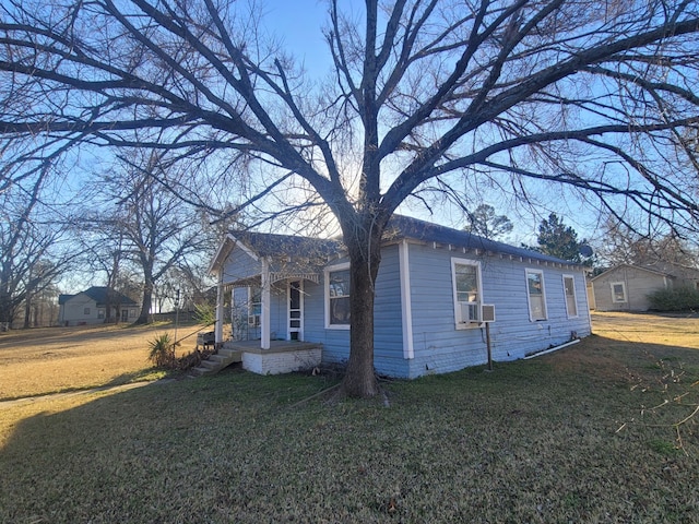 view of property exterior with cooling unit and a lawn