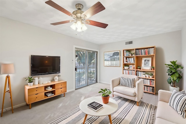 living room with ceiling fan and light colored carpet