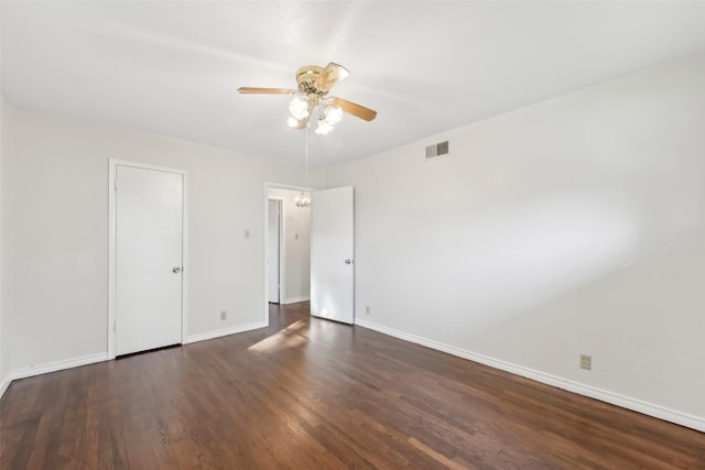 spare room featuring ceiling fan and dark hardwood / wood-style floors