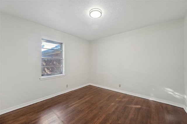 unfurnished room with hardwood / wood-style floors and a textured ceiling