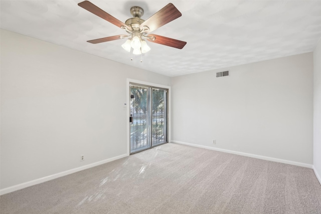 unfurnished room with ceiling fan and light carpet