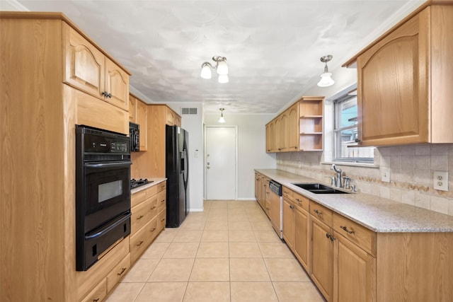 kitchen with black appliances, tasteful backsplash, light tile patterned floors, sink, and decorative light fixtures