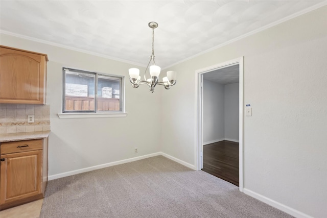 unfurnished dining area with light colored carpet, ornamental molding, and an inviting chandelier