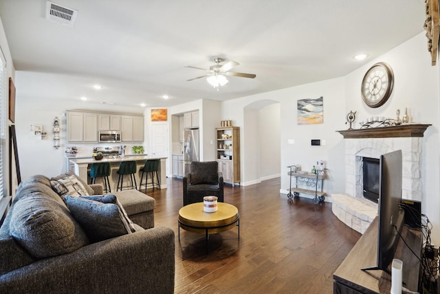 living room featuring dark hardwood / wood-style floors and ceiling fan