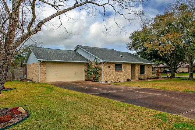 view of front of house featuring a front yard and a garage