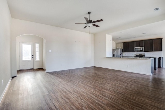 unfurnished living room with ceiling fan and dark hardwood / wood-style floors