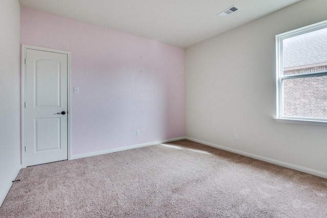 unfurnished room with plenty of natural light and light carpet