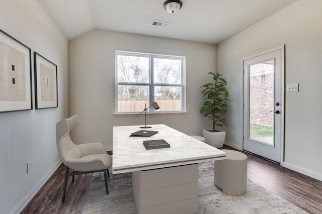 office featuring baseboards, dark wood-type flooring, visible vents, and a healthy amount of sunlight